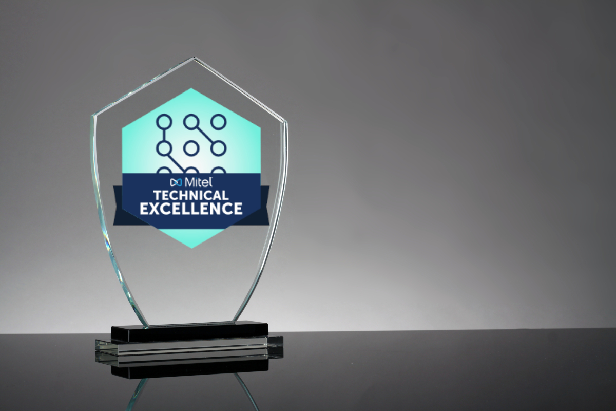 A glass trophy with the Mitel Technical Excellence Badge on it