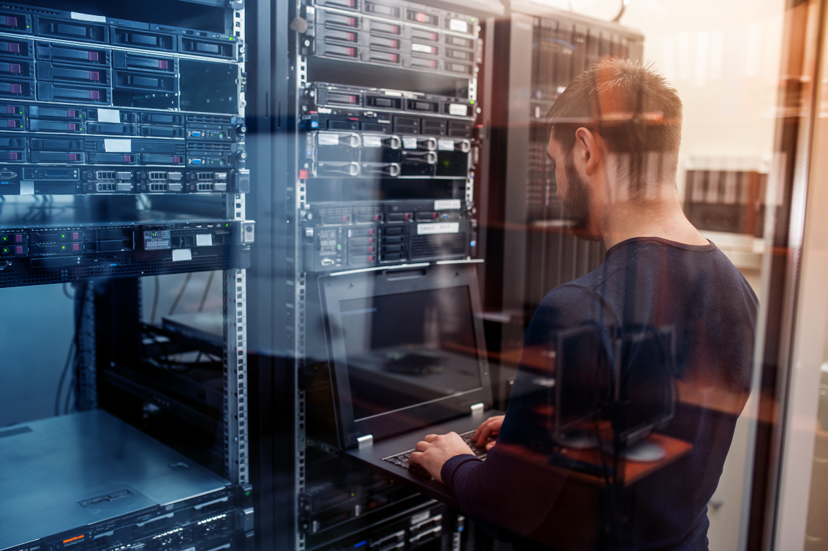 An IT employee working in a server room